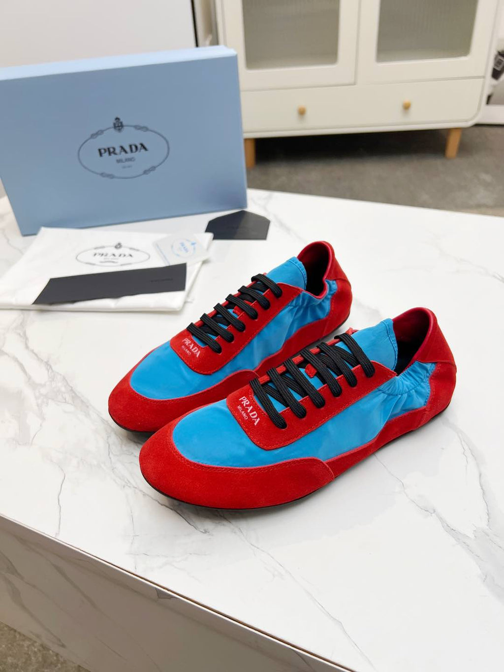 PRADA COLLAPSE SNEAKERS IN RED SUEDE AND SKY BLUE NYLON