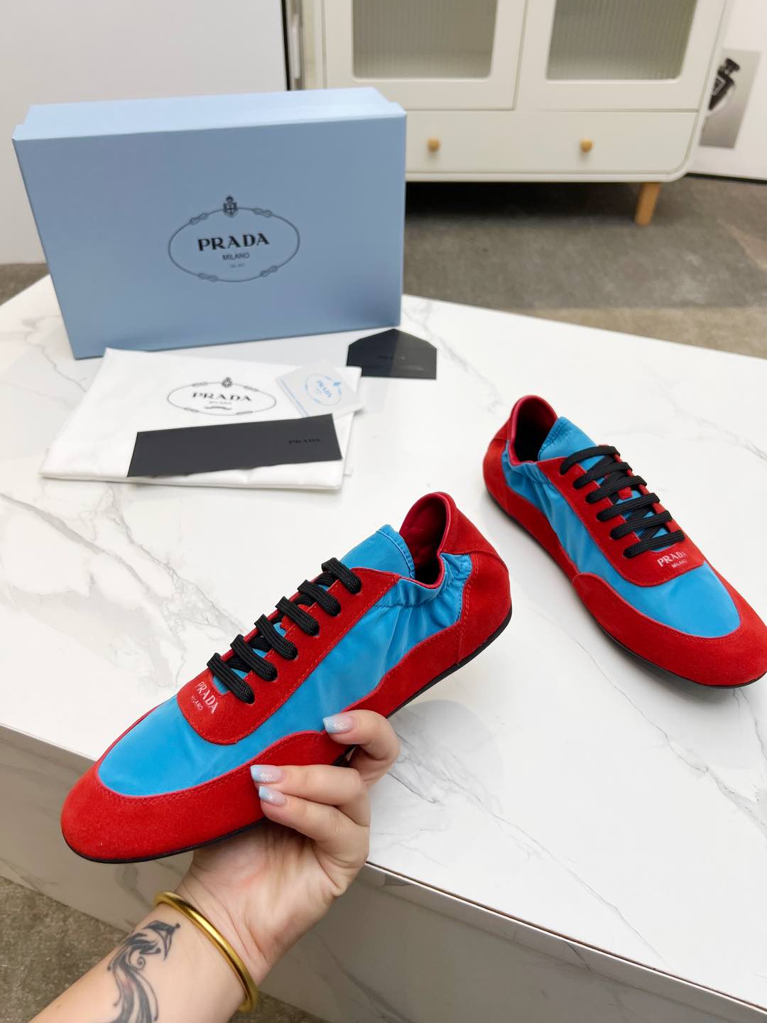 PRADA COLLAPSE SNEAKERS IN RED SUEDE AND SKY BLUE NYLON