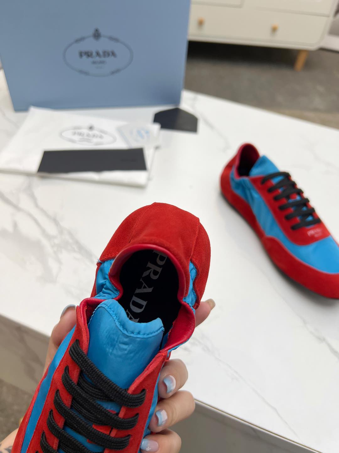PRADA COLLAPSE SNEAKERS IN RED SUEDE AND SKY BLUE NYLON